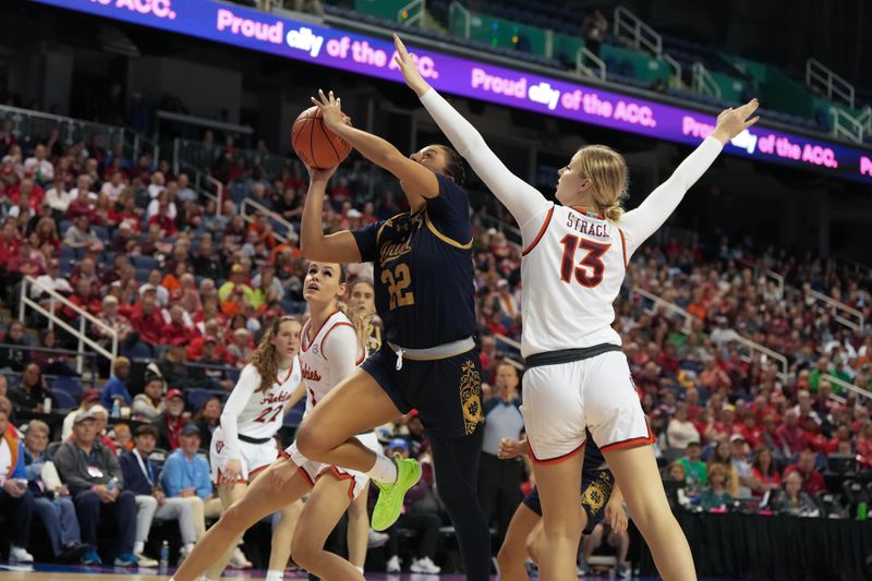 Mar 9, 2024; Greensboro, NC, USA; Notre Dame Fighting Irish forward Kylee Watson (22) shoots the ball over Virginia Tech Hokies center Clara Strack (13) during the second half at Greensboro Coliseum. Mandatory Credit: David Yeazell-USA TODAY Sports