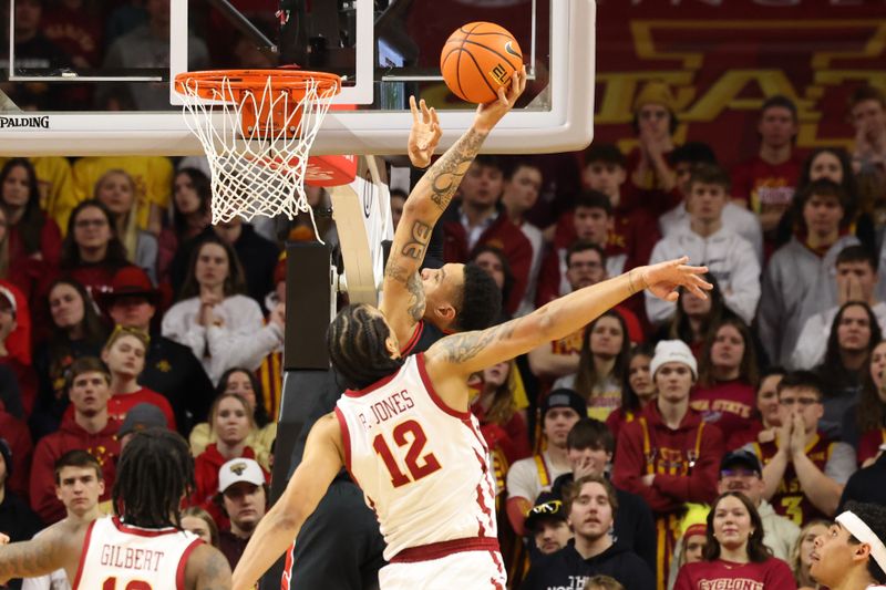 Feb 17, 2024; Ames, Iowa, USA; Texas Tech Red Raiders guard Chance McMillian (0) scores in front of Iowa State Cyclones defender forward Robert Jones (12) during the second half at James H. Hilton Coliseum. Mandatory Credit: Reese Strickland-USA TODAY Sports