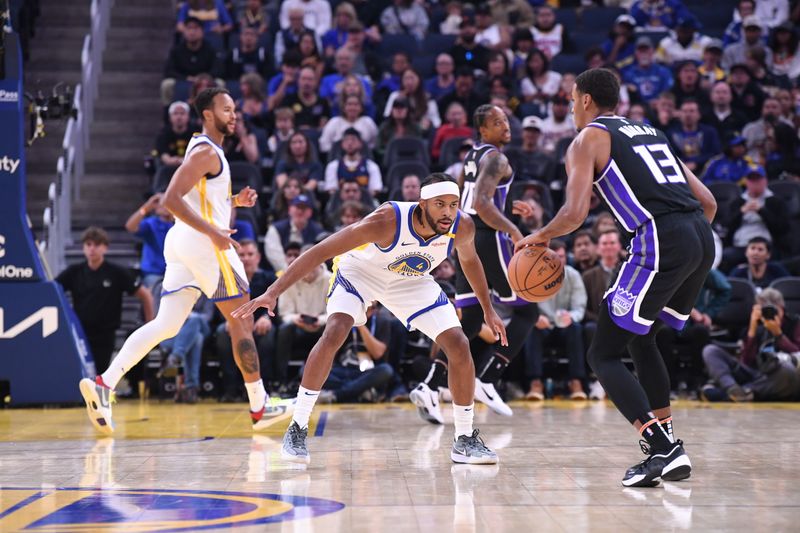 SAN FRANCISCO, CA - OCTOBER 11: Keegan Murray #13 of the Sacramento Kings handles the ball while Moses Moody #4 of the Golden State Warriors plays defense during a NBA Preseason game on October 11, 2024 at Chase Center in San Francisco, California. NOTE TO USER: User expressly acknowledges and agrees that, by downloading and or using this photograph, user is consenting to the terms and conditions of Getty Images License Agreement. Mandatory Copyright Notice: Copyright 2024 NBAE (Photo by Noah Graham/NBAE via Getty Images)