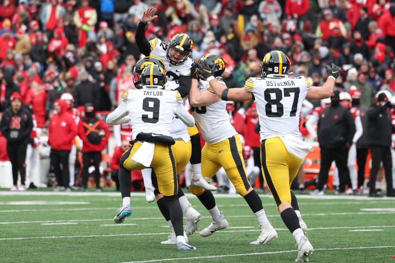 Nov 24, 2023; Lincoln, Nebraska, USA; Iowa Hawkeyes kicker Marshall Meeder (82) celebrates with teammates after kicking the game winning field goal against the Nebraska Cornhuskers at Memorial Stadium. Mandatory Credit: Reese Strickland-USA TODAY Sports