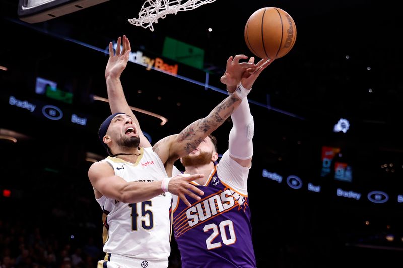 PHOENIX, ARIZONA - APRIL 07: Jusuf Nurkic #20 of the Phoenix Suns blocks a shot by Jose Alvarado #15 of the New Orleans Pelicans during the second half at Footprint Center on April 07, 2024 in Phoenix, Arizona. NOTE TO USER: User expressly acknowledges and agrees that, by downloading and or using this photograph, User is consenting to the terms and conditions of the Getty Images License Agreement.  (Photo by Chris Coduto/Getty Images)