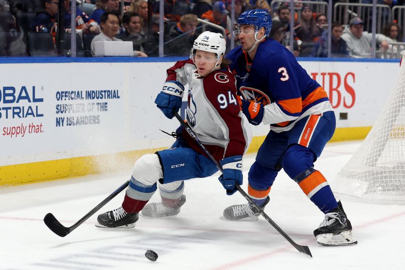 Jan 28, 2025; Elmont, New York, USA; Colorado Avalanche left wing Joel Kiviranta (94) and New York Islanders defenseman Adam Pelech (3) fight for the puck during the third period at UBS Arena. Mandatory Credit: Brad Penner-Imagn Images