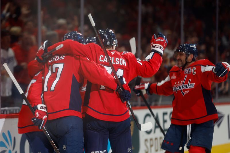 Oct 31, 2024; Washington, District of Columbia, USA; Washington Capitals center Aliaksei Protas (21) celebrates with teammates after scoring a goal against the Montreal Canadiens in the third period at Capital One Arena. Mandatory Credit: Geoff Burke-Imagn Images