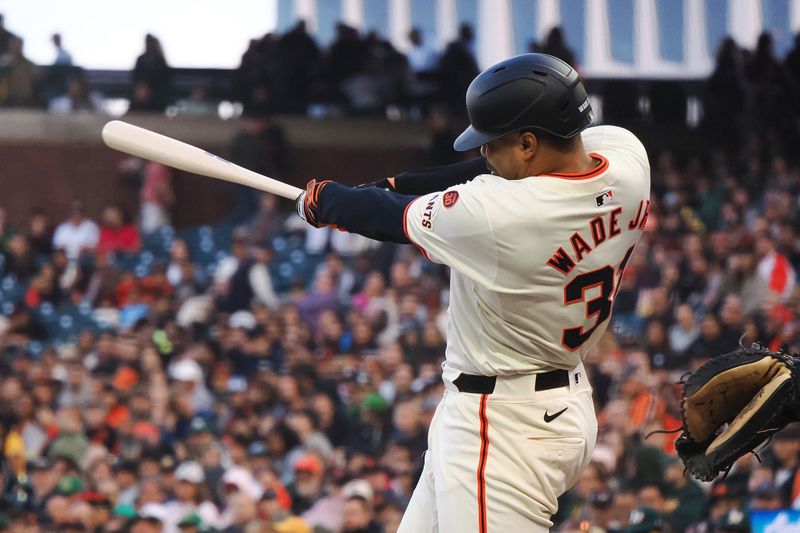 Jul 31, 2024; San Francisco, California, USA; San Francisco Giants first baseman LaMonte Wade Jr. (31) hits a double against the Oakland Athletics during the third inning at Oracle Park. Mandatory Credit: Kelley L Cox-USA TODAY Sports