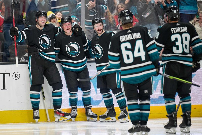 Mar 23, 2024; San Jose, California, USA; San Jose Sharks left wing Fabian Zetterlund (20) celebrates with center Klim Kostin (10) and defenseman Kyle Burroughs (4) after scoring a goal against the Chicago Blackhawks during the second period at SAP Center at San Jose. Mandatory Credit: Robert Edwards-USA TODAY Sports