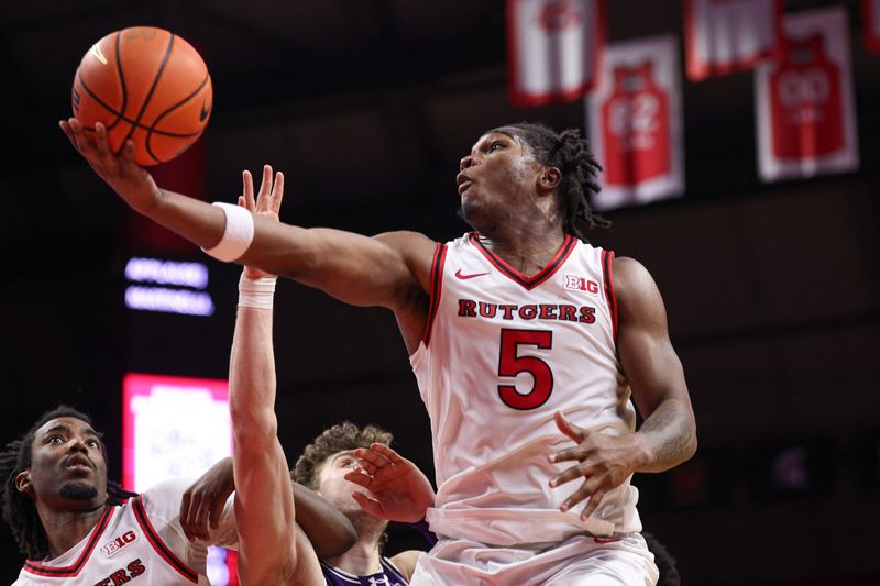 Jan 11, 2026; Piscataway, New Jersey, USA; Rutgers Scarlet Knights guard Darren Buchanan Jr. (5) drives to the basket during the second half against the Northwestern Wildcats at Jersey Mike's Arena. Mandatory Credit: Vincent Carchietta-Imagn Images