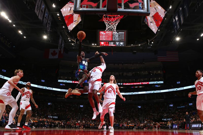 TORONTO, CANADA - MARCH 25: Dennis Schroder #17 of the Brooklyn Nets drives to the basket during the game against the Toronto Raptors on March 25, 2024 at the Scotiabank Arena in Toronto, Ontario, Canada.  NOTE TO USER: User expressly acknowledges and agrees that, by downloading and or using this Photograph, user is consenting to the terms and conditions of the Getty Images License Agreement.  Mandatory Copyright Notice: Copyright 2024 NBAE (Photo by Vaughn Ridley/NBAE via Getty Images)