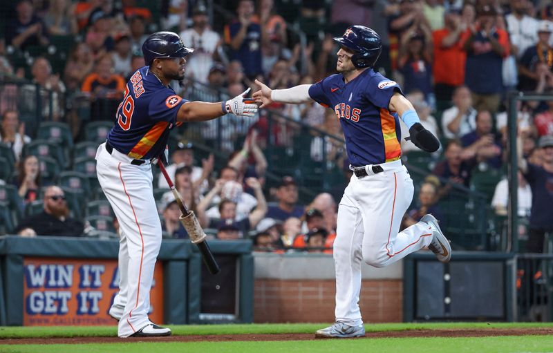 Jun 18, 2023; Houston, Texas, USA; Houston Astros third baseman Alex Bregman (2) celebrates with first baseman Jose Abreu (79) after scoring a run during the first inning against the Cincinnati Reds at Minute Maid Park. Mandatory Credit: Troy Taormina-USA TODAY Sports