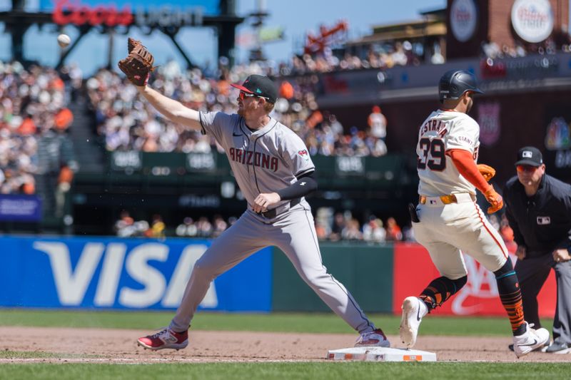 Apr 21, 2024; San Francisco, California, USA;  San Francisco Giants second baseman Thairo Estrada (39) as Arizona Diamondbacks first baseman Pavin Smith (26) catches the ball during the fifth inning at Oracle Park. Mandatory Credit: John Hefti-USA TODAY Sports