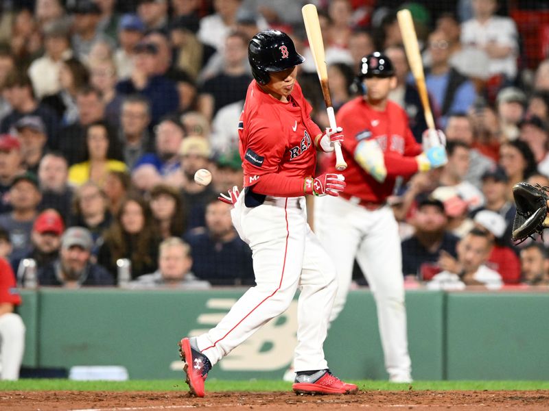 Sep 6, 2024; Boston, Massachusetts, USA; Boston Red Sox left fielder Masataka Yoshida (7) is hit by a pitch thrown by Chicago White Sox starting pitcher Davis Martin (65) during the sixth inning at Fenway Park. Mandatory Credit: Brian Fluharty-Imagn Images