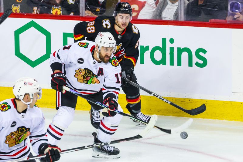 Jan 27, 2024; Calgary, Alberta, CAN; Chicago Blackhawks left wing Nick Foligno (17) controls the puck against the Calgary Flames during the first period at Scotiabank Saddledome. Mandatory Credit: Sergei Belski-USA TODAY Sports