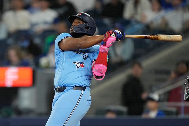 May 29, 2025; Toronto, Ontario, CAN; Toronto Blue Jays first baseman Vladimir Guerrero (27) hits a two run home run against the Athletics during the second inning at Rogers Centre. Mandatory Credit: John E. Sokolowski-Imagn Images