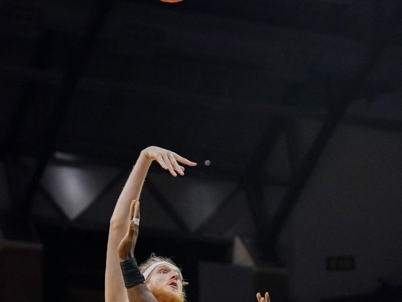 Jan 6, 2024; Columbia, Missouri, USA; Missouri Tigers center Connor Vanover (75) shoots over Georgia Bulldogs center Russel Tchewa (54) during the first half at Mizzou Arena. Mandatory Credit: Denny Medley-USA TODAY Sports