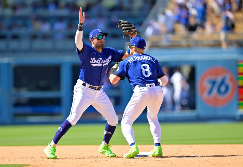 Aug 13, 2023; Los Angeles, California, USA; Los Angeles Dodgers shortstop Miguel Rojas (11) and second baseman Enrique Hernandez (8) celebrate after the final out of the ninth inning defeating the Colorado Rockies at Dodger Stadium. Mandatory Credit: Jayne Kamin-Oncea-USA TODAY Sports