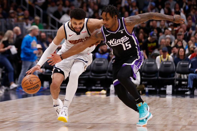 DENVER, COLORADO - FEBRUARY 28: Jamal Murray #27 of the Denver Nuggets brings the ball up court against Davion Mitchell #15 of the Sacramento Kings at Ball Arena on February 28, 2024 in Denver, Colorado. NOTE TO USER: User expressly acknowledges and agrees that, by downloading and or using this photograph, User is consenting to the terms and conditions of the Getty Images License Agreement. (Photo by Brendall O'Banon/Clarkson Creative/Getty Images)