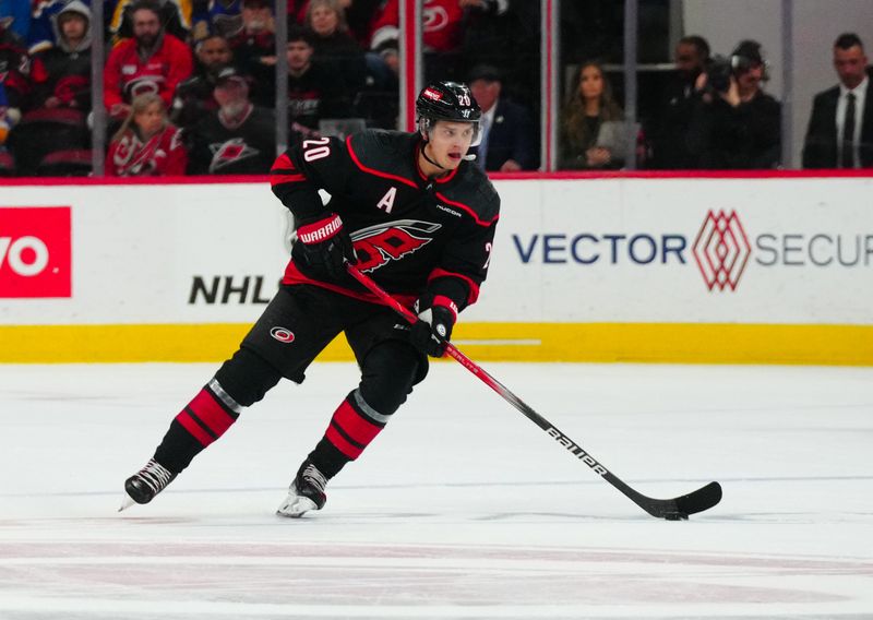 Jan 6, 2024; Raleigh, North Carolina, USA; Carolina Hurricanes center Sebastian Aho (20) skates with the puck against the St. Louis Blues during the first period at PNC Arena. Mandatory Credit: James Guillory-USA TODAY Sports