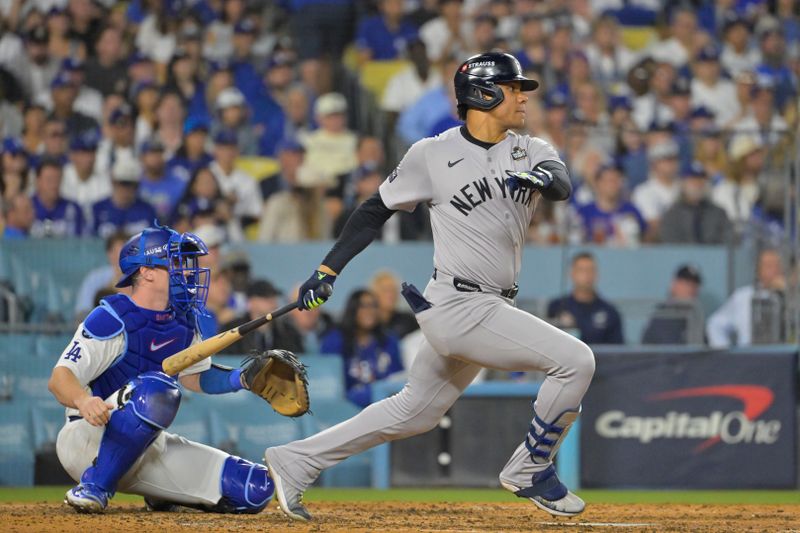 Oct 25, 2024; Los Angeles, California, USA; New York Yankees outfielder Juan Soto (22) hits a single in the sixth inning against the Los Angeles Dodgers during game one of the 2024 MLB World Series at Dodger Stadium. Mandatory Credit:  Jayne Kamin-Oncea-Imagn Images