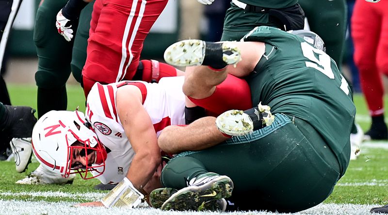 Nov 4, 2023; East Lansing, Michigan, USA;  Michigan State Spartans defensive lineman Maverick Hansen (97) sacks Nebraska Cornhuskers quarterback Heinrich Haarberg (10) in the first quarter at Spartan Stadium. Mandatory Credit: Dale Young-USA TODAY Sports