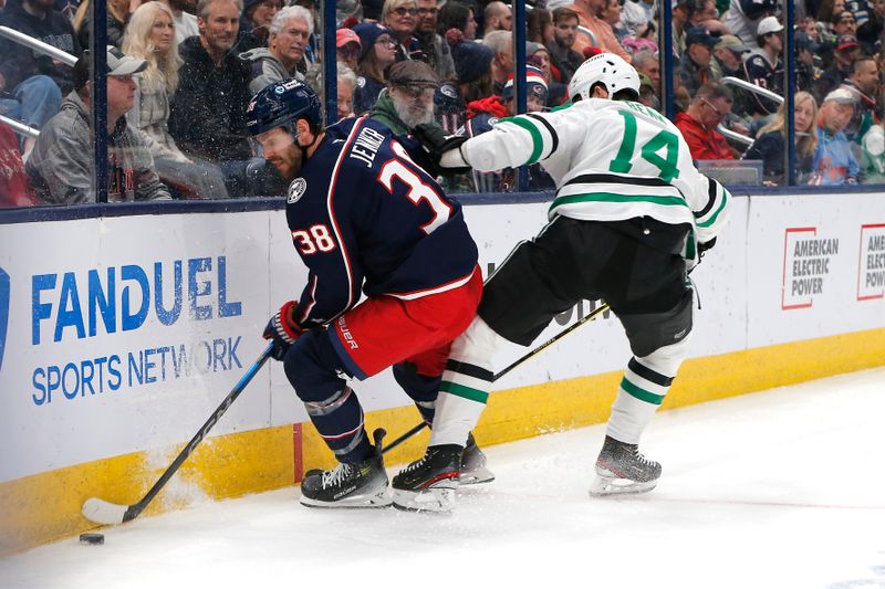 Feb 25, 2025; Columbus, Ohio, USA; Columbus Blue Jackets center Boone Jenner (38) and Dallas Stars left wing Jamie Benn (14) battle for the puck during the second period at Nationwide Arena. Mandatory Credit: Russell LaBounty-Imagn Images