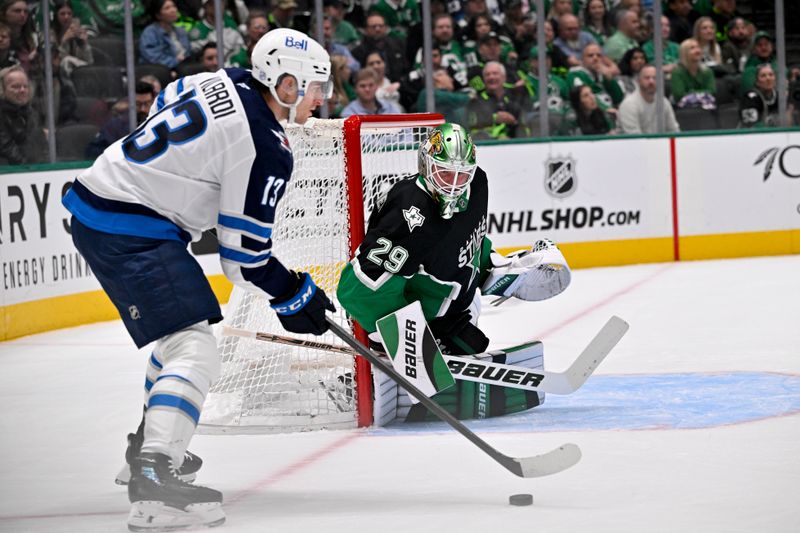 Feb 2, 2026; Dallas, Texas, USA; Winnipeg Jets center Gabriel Vilardi (13) looks to pass the puck in front of Dallas Stars goaltender Jake Oettinger (29) during the first period at the American Airlines Center. Mandatory Credit: Jerome Miron-Imagn Images