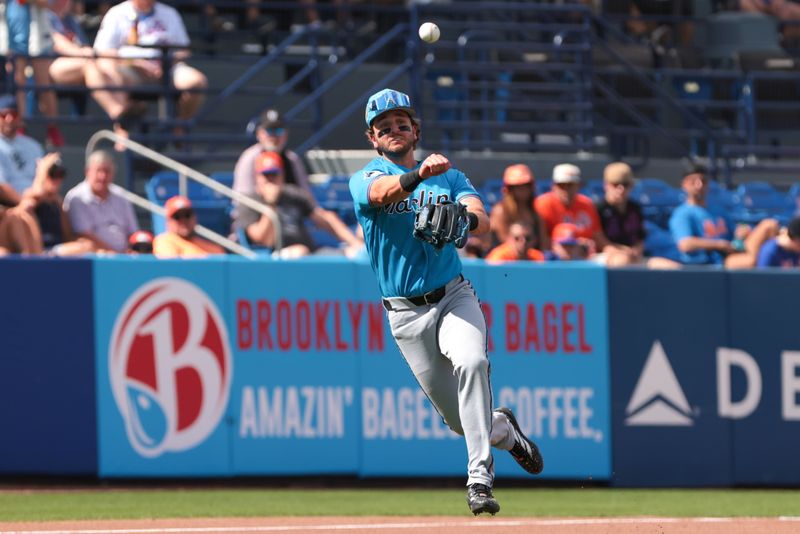 Feb 21, 2026; Port St. Lucie, Florida, USA; Miami Marlins third baseman Connor Norby (1) throws to first base but cannot retire New York Mets shortstop Ronny Mauricio (not pictured) during the second inning at Clover Park. Mandatory Credit: Sam Navarro-Imagn Images