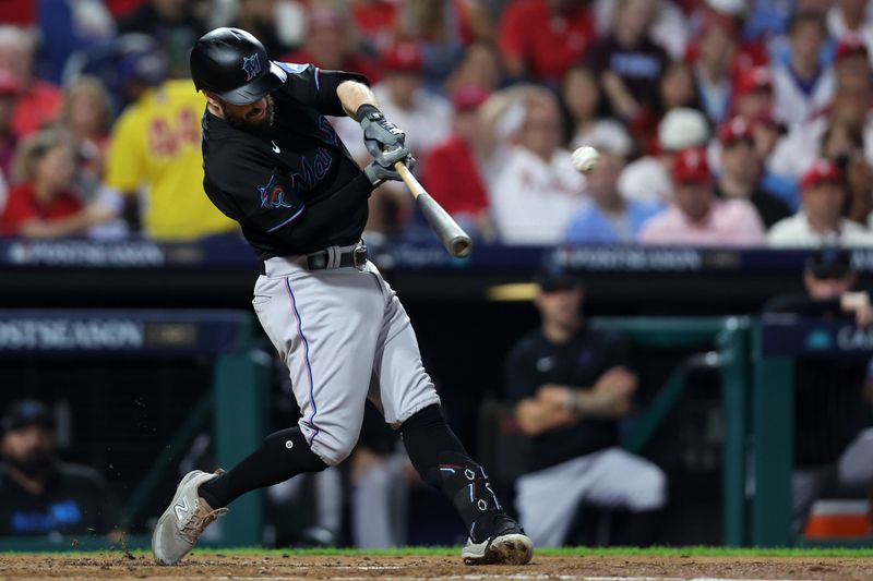 Oct 4, 2023; Philadelphia, Pennsylvania, USA; Miami Marlins shortstop Jon Berti (5) hits a double against the Philadelphia Phillies during the third inning for game two of the Wildcard series for the 2023 MLB playoffs at Citizens Bank Park. Mandatory Credit: Bill Streicher-USA TODAY Sports