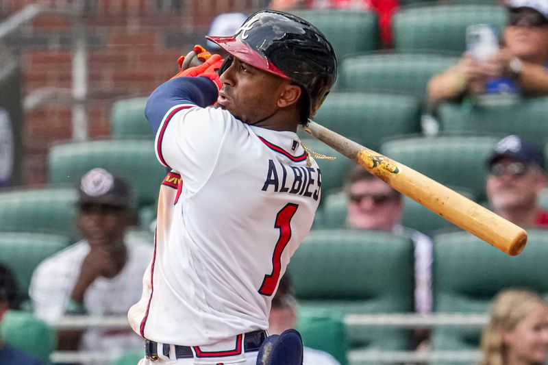 Aug 2, 2023; Cumberland, Georgia, USA; Atlanta Braves second baseman Ozzie Albies (1) hits a double to drive in a run against the Los Angeles Angels during the eighth inning at Truist Park. Mandatory Credit: Dale Zanine-USA TODAY Sports