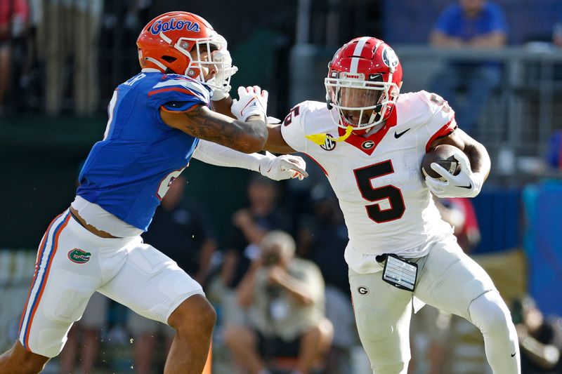 Oct 28, 2023; Jacksonville, Florida, USA; Georgia Bulldogs wide receiver Rara Thomas (5) runs against Florida Gators cornerback Jalen Kimber (8) in the first half at EverBank Stadium. Mandatory Credit: Jeff Swinger-USA TODAY Sports