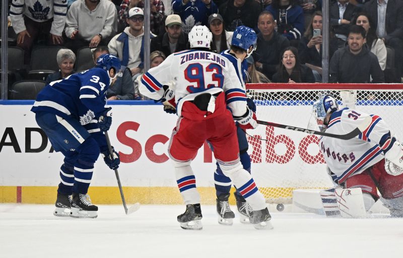 Oct 16, 2025; Toronto, Ontario, CAN; Toronto Maple Leafs forward Auston Matthews (34) scores the winning goal in overtime past New York Rangers goalie Igor Shesterkin (31)at Scotiabank Arena. Mandatory Credit: Dan Hamilton-Imagn Images