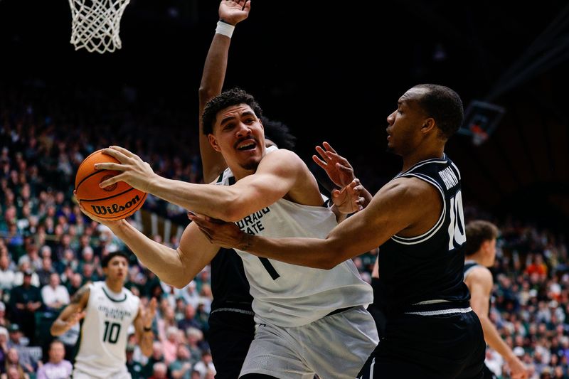 Feb 17, 2024; Fort Collins, Colorado, USA; Colorado State Rams forward Joel Scott (1) looks to pass the ball under pressure from Utah State Aggies guard Darius Brown II (10) in the second half at Moby Arena. Mandatory Credit: Isaiah J. Downing-USA TODAY Sports