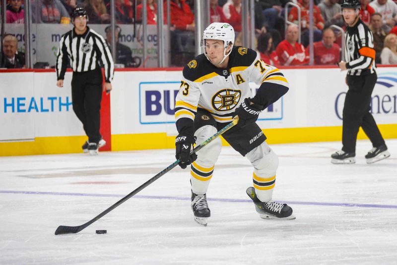 Nov 23, 2024; Detroit, Michigan, USA; Boston Bruins defenseman Charlie McAvoy (73) handles the puck during the first period of the game against the Detroit Red Wings at Little Caesars Arena. Mandatory Credit: Brian Bradshaw Sevald-Imagn Images