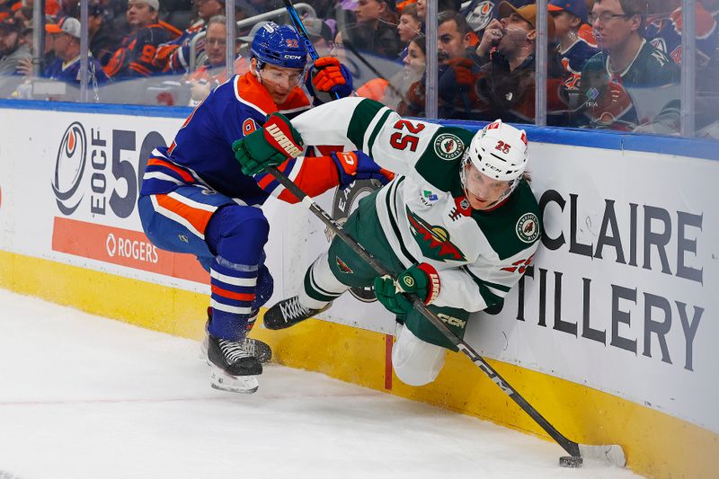 Nov 21, 2024; Edmonton, Alberta, CAN; Edmonton Oilers forward Vasily Podkolzin (92) and Minnesota Wild defensemen Jonas Brodin (25) battle along the boards for a loose puck  during the first period at Rogers Place. Mandatory Credit: Perry Nelson-Imagn Images