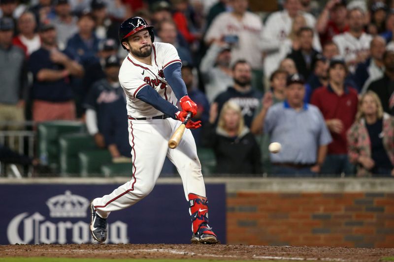 Oct 12, 2022; Atlanta, Georgia, USA; Atlanta Braves catcher Travis d'Arnaud (16) hits an RBI single against the Philadelphia Phillies in the sixth inning during game two of the NLDS for the 2022 MLB Playoffs at Truist Park. Mandatory Credit: Brett Davis-USA TODAY Sports