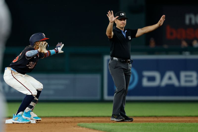 Jun 4, 2025; Washington, District of Columbia, USA; Washington Nationals shortstop Nasim Nuñez (26) celebrates towards his dugout at second base after hitting an RBI double against the Chicago Cubs during the eighth inning at Nationals Park. Mandatory Credit: Geoff Burke-Imagn Images