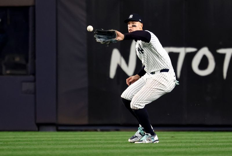 Oct 30, 2024; New York, New York, USA; New York Yankees outfielder Aaron Judge (99) makes a fielding error during the fifth inning against the Los Angeles Dodgers in game five of the 2024 MLB World Series at Yankee Stadium. Mandatory Credit: Vincent Carchietta-Imagn Images