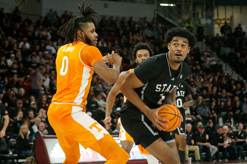 Jan 17, 2023; Starkville, Mississippi, USA; Mississippi State Bulldogs forward Tolu Smith (1) spins toward the basket as Tennessee Volunteers forward Jonas Aidoo (0) defends during the second half at Humphrey Coliseum. Mandatory Credit: Petre Thomas-USA TODAY Sports