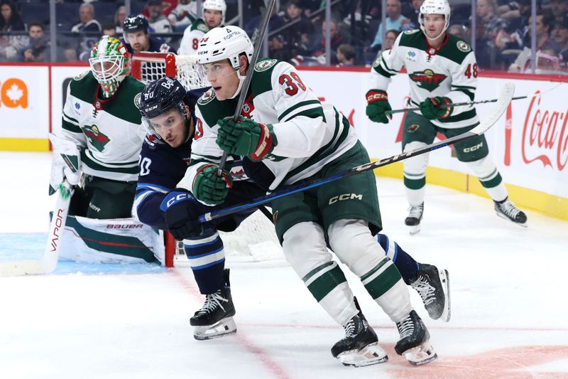 Sep 21, 2025; Winnipeg, Manitoba, CAN; Minnesota Wild center Ben Jones (39) is checked by Winnipeg Jets right wing Nikita Chibrikov (90) in the second period at Canada Life Centre. Mandatory Credit: James Carey Lauder-Imagn Images