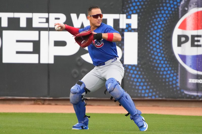 Mar 24, 2024; Peoria, Arizona, USA; Chicago Cubs catcher Miguel Amaya (9) warms up before a game against the Seattle Mariners at Peoria Sports Complex. Mandatory Credit: Rick Scuteri-USA TODAY Sports