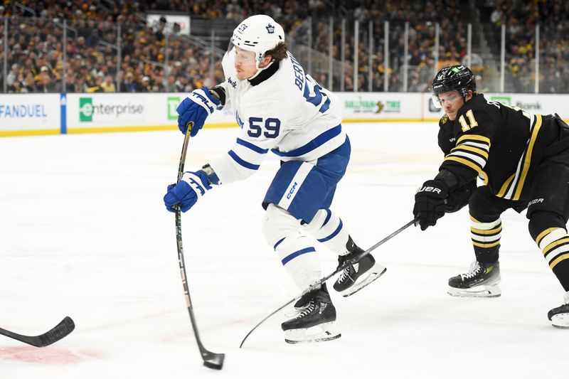 May 4, 2024; Boston, Massachusetts, USA; Toronto Maple Leafs left wing Tyler Bertuzzi (59) shoots the puck while Boston Bruins center Trent Frederic (11) defends during the second period in game seven of the first round of the 2024 Stanley Cup Playoffs at TD Garden. Mandatory Credit: Bob DeChiara-USA TODAY Sports