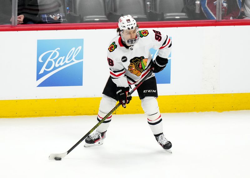 Mar 4, 2024; Denver, Colorado, USA; Chicago Blackhawks center Connor Bedard (98) controls the puck in the first period against the Colorado Avalanche at Ball Arena. Mandatory Credit: Ron Chenoy-USA TODAY Sports