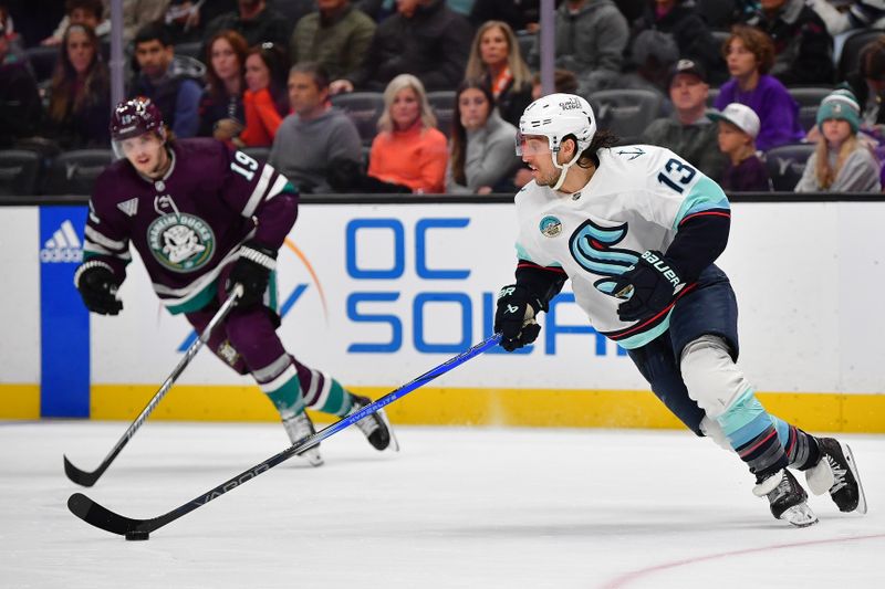 Apr 5, 2024; Anaheim, California, USA; Seattle Kraken left wing Brandon Tanev (13) moves the puck against the Anaheim Ducks during the second period at Honda Center. Mandatory Credit: Gary A. Vasquez-USA TODAY Sports