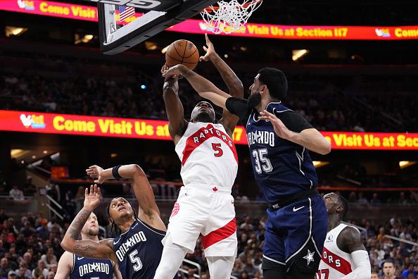 ORLANDO, FLORIDA - NOVEMBER 21: Precious Achiuwa #5 of the Toronto Raptors shoots over Goga Bitadze #35 of the Orlando Magic during the third quarter of an NBA In-Season Tournament game at Amway Center on November 21, 2023 in Orlando, Florida. NOTE TO USER: User expressly acknowledges and agrees that, by downloading and or using this photograph, User is consenting to the terms and conditions of the Getty Images License Agreement. (Photo by Rich Storry/Getty Images)