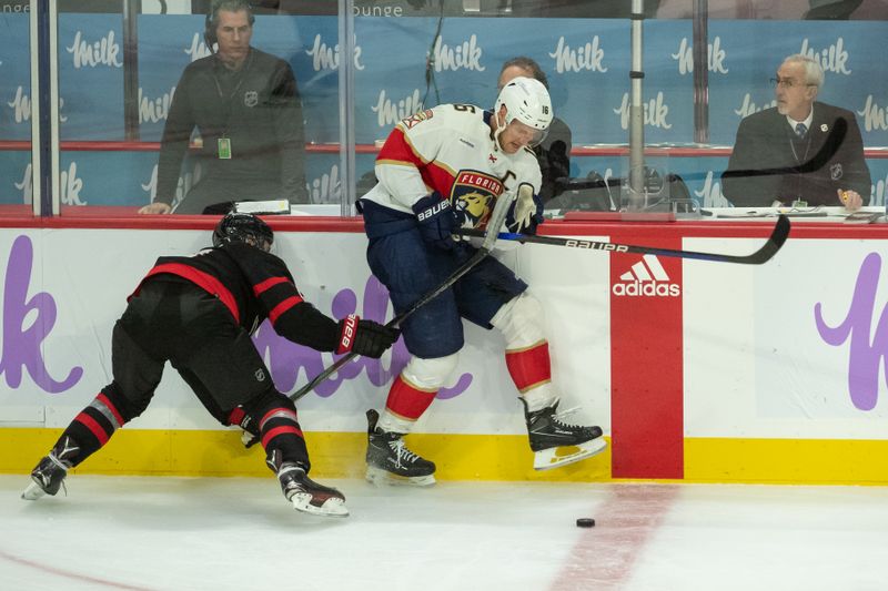 Nov 27 2023; Ottawa, Ontario, CAN; Florida Panthers center Aleksander Barkov (16) skates past Ottawa Senators defenseman Artem Zub (2) in the third period at the Canadian Tire Centre. Mandatory Credit: Marc DesRosiers-USA TODAY Sports