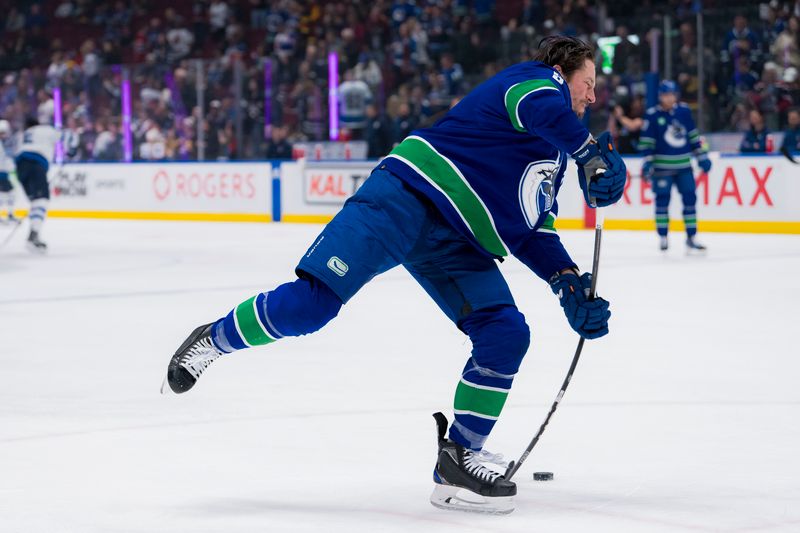 Mar 9, 2024; Vancouver, British Columbia, CAN; Vancouver Canucks forward J.T. Miller (9) shoots during warm up prior to a game against the Winnipeg Jets at Rogers Arena. Mandatory Credit: Bob Frid-USA TODAY Sports