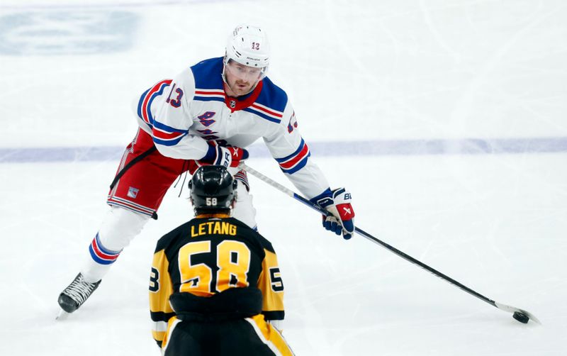 Mar 16, 2024; Pittsburgh, Pennsylvania, USA;  New York Rangers left wing Alexis Lafreniere (13) skates up ice with the puck against the Pittsburgh Penguins defenseman Kris Letang (58) during the third period at PPG Paints Arena. New York won 7-4. Mandatory Credit: Charles LeClaire-USA TODAY Sports