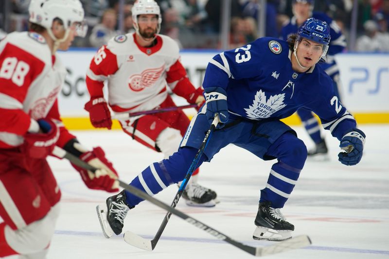 Nov 8, 2024; Toronto, Ontario, CAN; Toronto Maple Leafs forward Matthew Knies (23) defends against Detroit Red Wings forward Patrick Kane (88) during the third period at Scotiabank Arena. Mandatory Credit: John E. Sokolowski-Imagn Images
