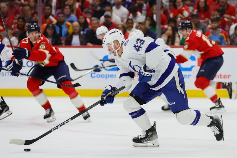 Apr 21, 2024; Sunrise, Florida, USA; Tampa Bay Lightning defenseman Darren Raddysh (43) moves the puck against the Florida Panthers during the first period in game one of the first round of the 2024 Stanley Cup Playoffs at Amerant Bank Arena. Mandatory Credit: Sam Navarro-USA TODAY Sports