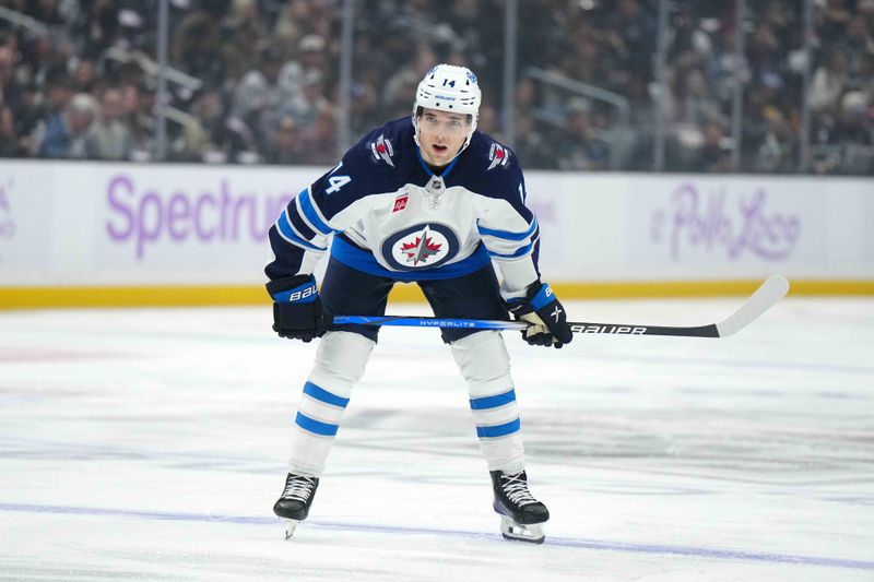 Nov 27, 2024; Los Angeles, California, USA; Winnipeg Jets defenseman Ville Heinola (14) against the LA Kings in the first period at Crypto.com Arena. Mandatory Credit: Kirby Lee-Imagn Images