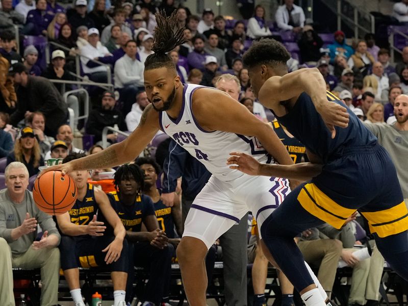 Jan 31, 2023; Fort Worth, Texas, USA; TCU Horned Frogs center Eddie Lampkin Jr. (4) controls the ball against West Virginia Mountaineers forward Mohamed Wague (11) during the first half at Ed and Rae Schollmaier Arena. Mandatory Credit: Chris Jones-USA TODAY Sports