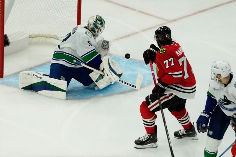 Oct 22, 2024; Chicago, Illinois, USA; Vancouver Canucks goaltender Kevin Lankinen (32)  makes a save on Chicago Blackhawks left wing Patrick Maroon (77) during the third period at United Center. Mandatory Credit: David Banks-Imagn Images